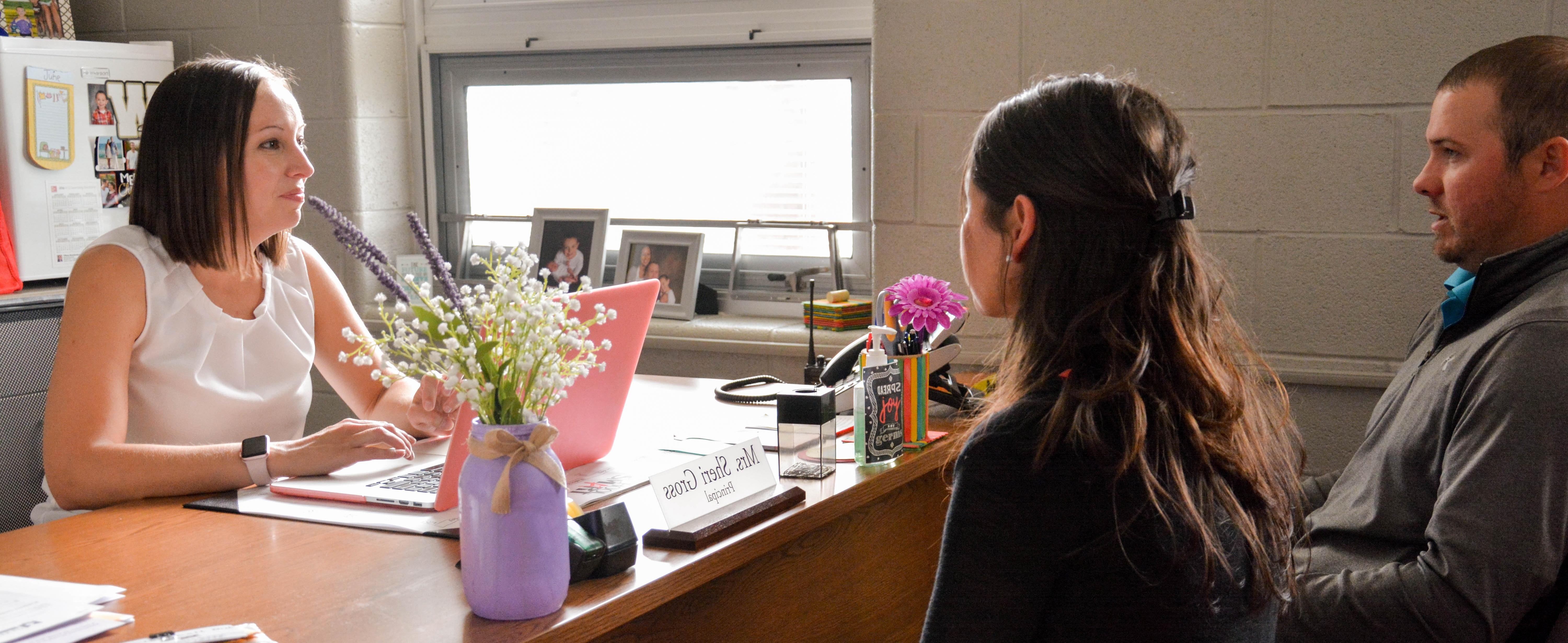 Elementary school principal having a meeting in her office 